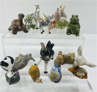 Animal figurines and shells. The red bird is