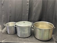 Three metal pots, one with lid