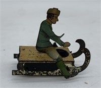early French man on sled tin litho penny toy