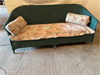 Green wicker counch with pad and 2 pillows
