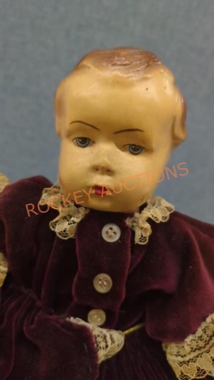 Antique doll with velvet dress