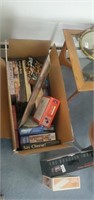Box of assorted jigsaw puzzles.