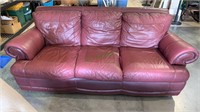 Light burgundy leather sofa - three person couch.
