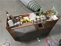 Small wooden desk with random assortment of