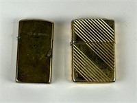 Two Zippos smaller solid Brass gold colored one