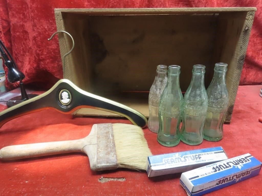 Wood crate, wall paper brush, coco cola bottles.