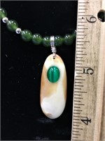 Jade bead necklace with an ivory pendant       (k