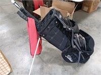 Titleist golf clubs and bag with stand.