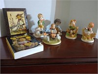 Group of figurines with a Hummel book and small