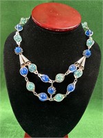 Silvertone necklace with blue and greenish beads.