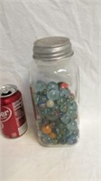 Tall canning jar full of old marbles