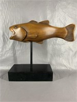 A Hand Carved Fish On Stand