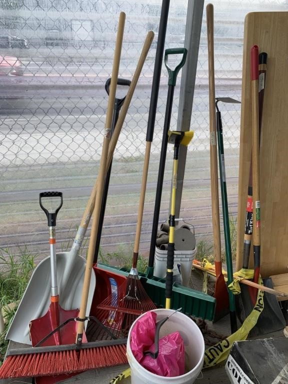 Large lot of yard tools: snow shovels, rake, push