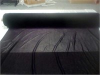 Roll of black sheer fabric with iridescent purple