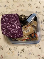 Container with necklaces, glasses case, bag and