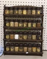 Vintage spice rack with glass spice jars.