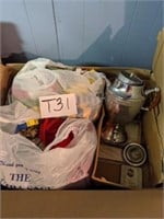 Box of clothes and large ornate coffee maker