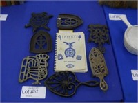 SEVEN COLLECTIBLE TRIVETS & AUTOGRAPHED BOOK ON