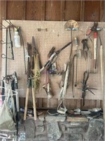 Yard implements hanging on wall under carport