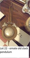 Old clock pendulum w grape leaves