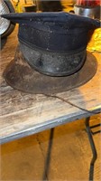 Two older hats one metal one cloth