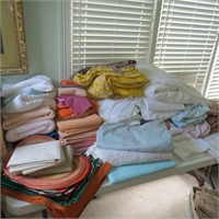 Large Table Full of Linens & Fabric