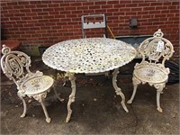 Wrought iron table in two chairs