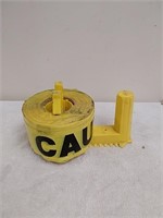 Roll of caution tape with holder