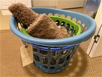 Three laundry baskets with two bath rugs