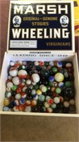 Cigar box of marbles, at least 7 shooters. Marsh