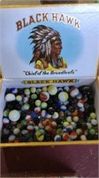 Cigar box of marbles, at least 9 shooters. Black