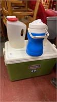 Lot of water jugs and cooler chest