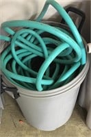 Garden hoses and garbage can