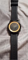 Black and gold digital watch. Scratches on face