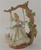 Porcelain doll on swing, 13"