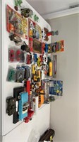 Box of assorted cars, trucks, and toys, including