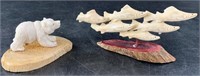 Lot of bone carvings: 1 is school of salmon and 1