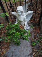 Plastic angel with plant 27 inches tall.
