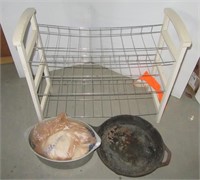 Shoe rack, cast iron pan and aluminum pot.