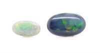 Two loose black and white solid opals