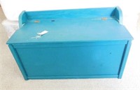 Teal blue wooden toy box and children’s toys