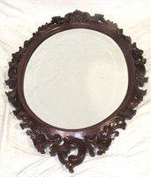 Heavily carved oval wall mirror