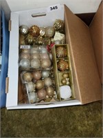 BOX OF GOLD COLORED TREE ORNAMENTS