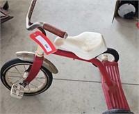 child's red tricycle