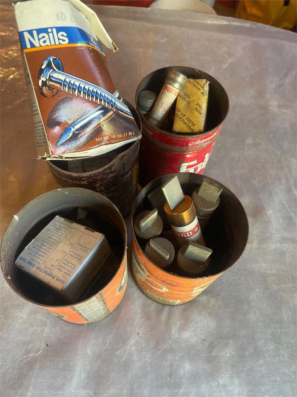 Coffee cans of fuses and nails