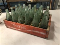 Lot of vintage coke bottles in crate