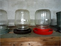 2 old glass chicken waterer's w/ plastic bases