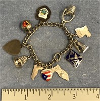 Charm bracelet with several charms, including diff