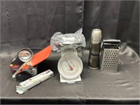 Kitchen scale, grater, soup ladle, mug, and scisso