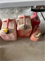 Group of four plastic gas cans